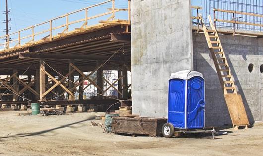 multiple porta potties arranged at a busy job site